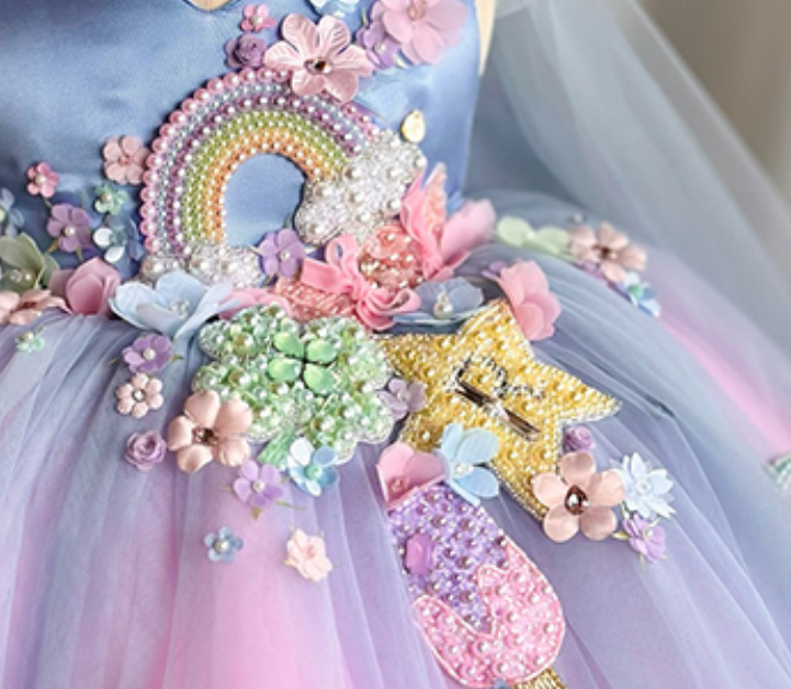 Decorative item with rainbow, flowers, and stars on a tulle background