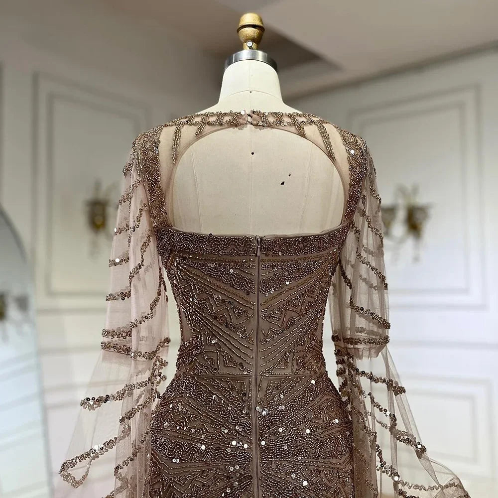 Golden hour mermaid gown with cape sleeves