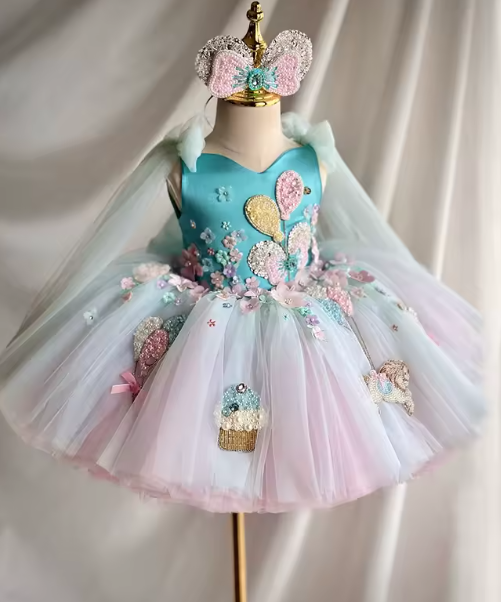 Colorful children's dress with floral details on a mannequin against a plain background