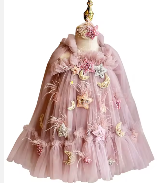 Pink dress with floral and moon designs on a mannequin against a white background