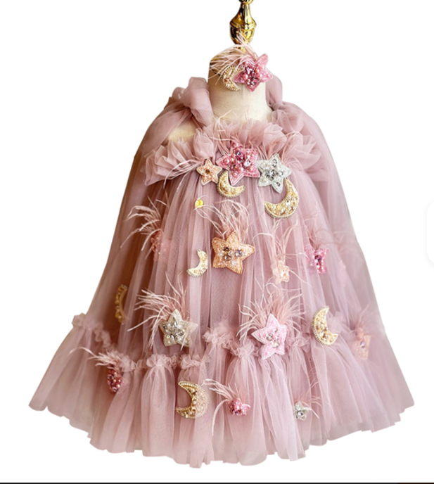 Pink tulle dress with decorative elements on a mannequin against a white background