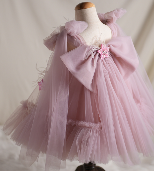 Pink tulle dress on a mannequin against a neutral background