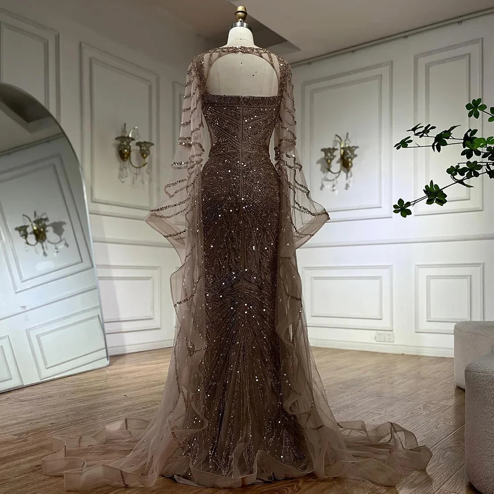 Golden hour mermaid gown with cape sleeves