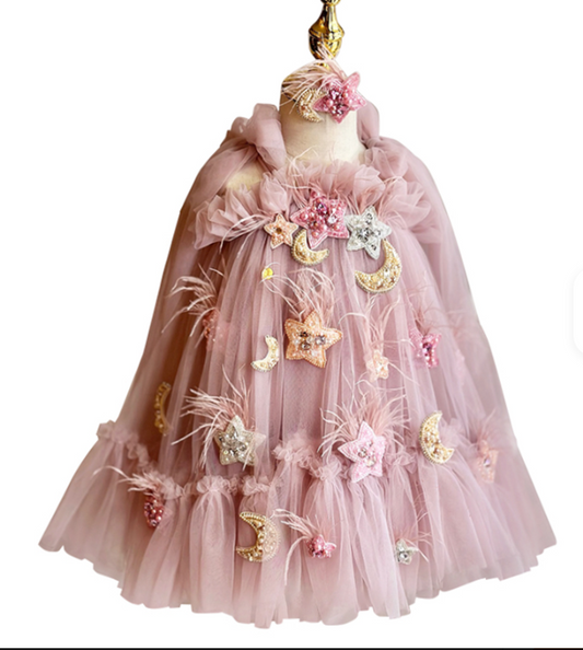 Pink tulle dress with decorative elements on a mannequin against a white background